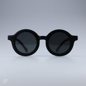 Roundabouts Matte Black kids sunglasses, front view on grey