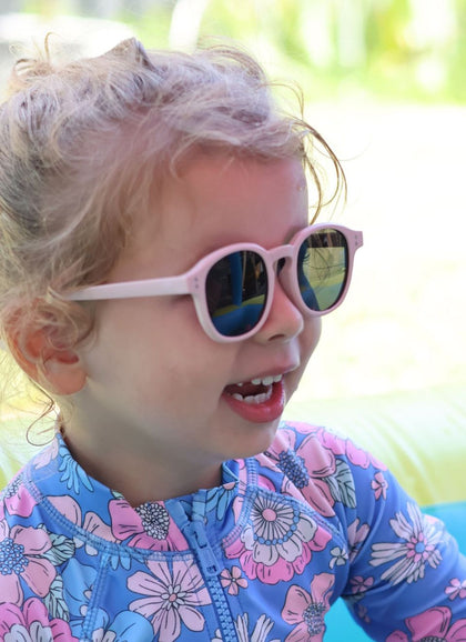 A child wearing Hey Peeps City Slickers sunglasses in Light Dusty Pink