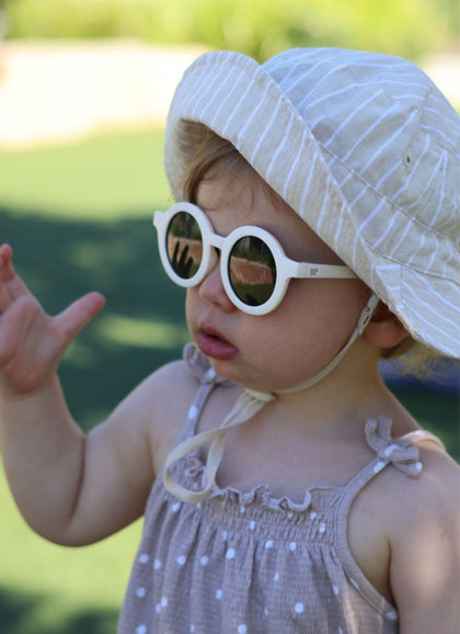 A child wearing Hey Peeps sunglasses in White