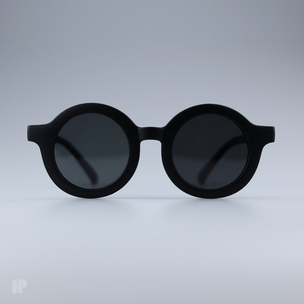 Roundabouts Matte Black kids sunglasses, front view on grey