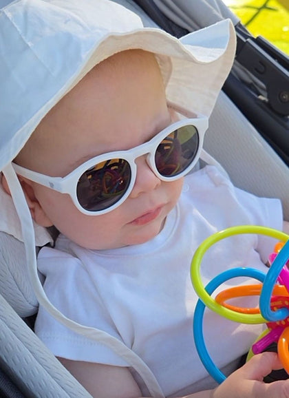 A child wearing Hey Peeps  sunglasses in White