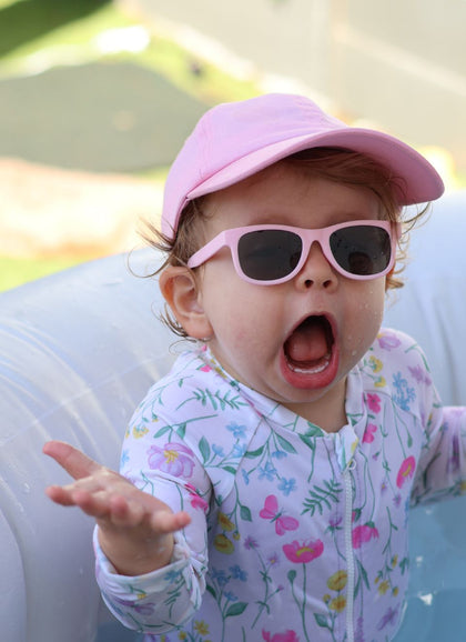 A child wearing Hey Peeps Little Legends sunglasses in Pink