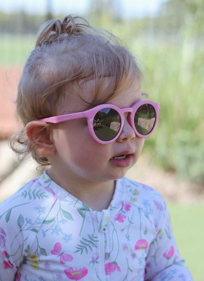 A child wearing Hey Peeps Retro Classics sunglasses in Pink